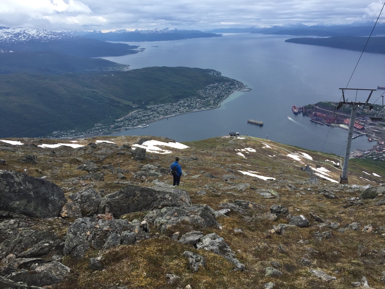 Climbing down a slope above Norwegian fjords.